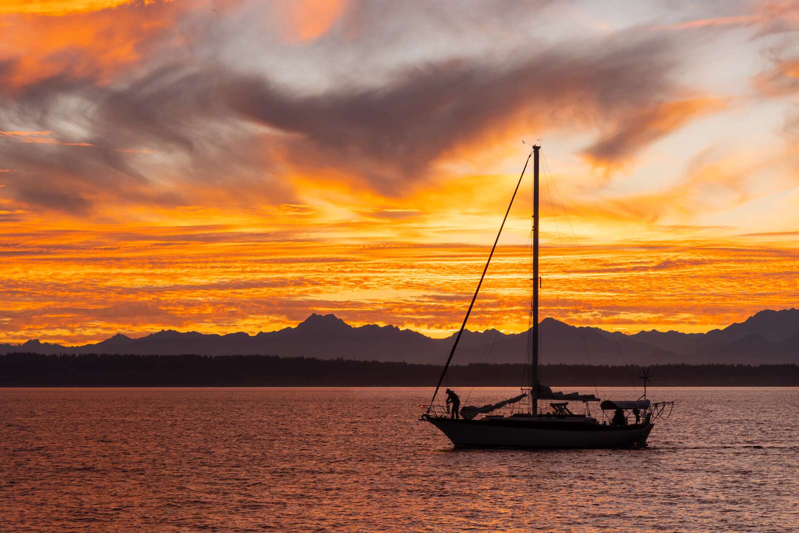 Boat sailing in front of sunset over the Olympic Peninsula